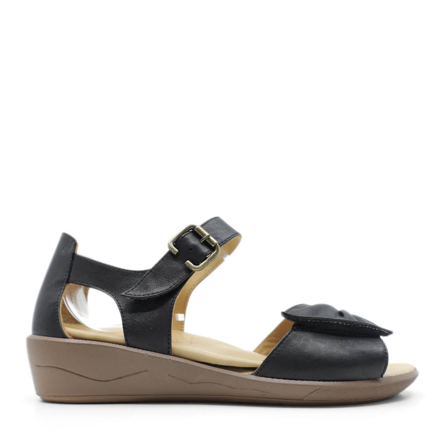 SIDE VIEW OF BLACK DUAL VELCRO CLOSED BACK SANDAL WITH DECORATIVE BUCKLE 
