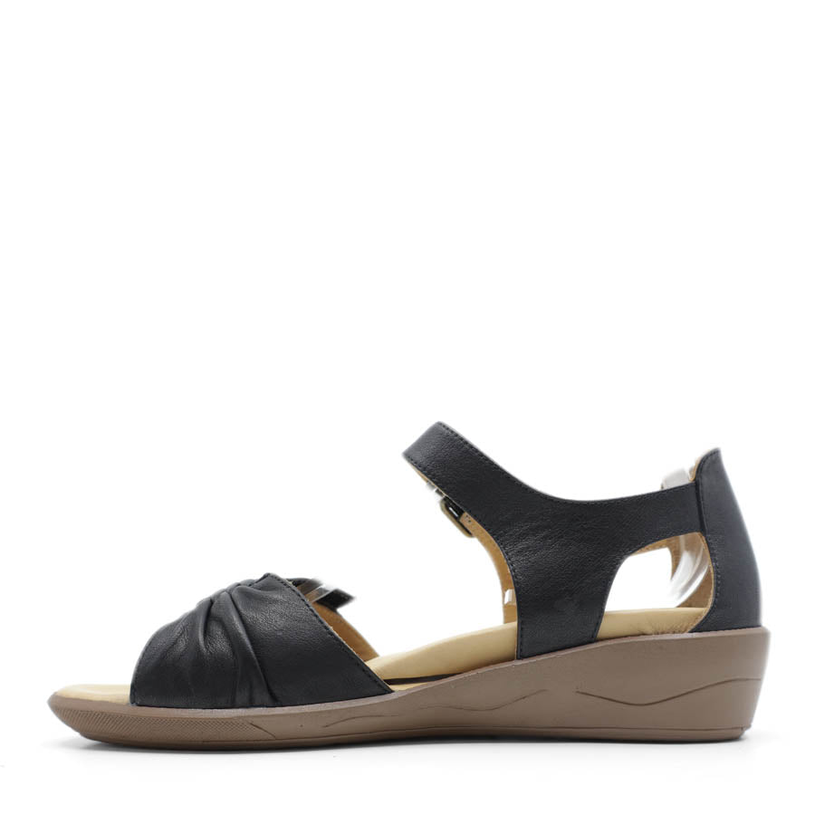 SIDE VIEW OF BLACK DUAL VELCRO CLOSED BACK SANDAL WITH DECORATIVE BUCKLE 