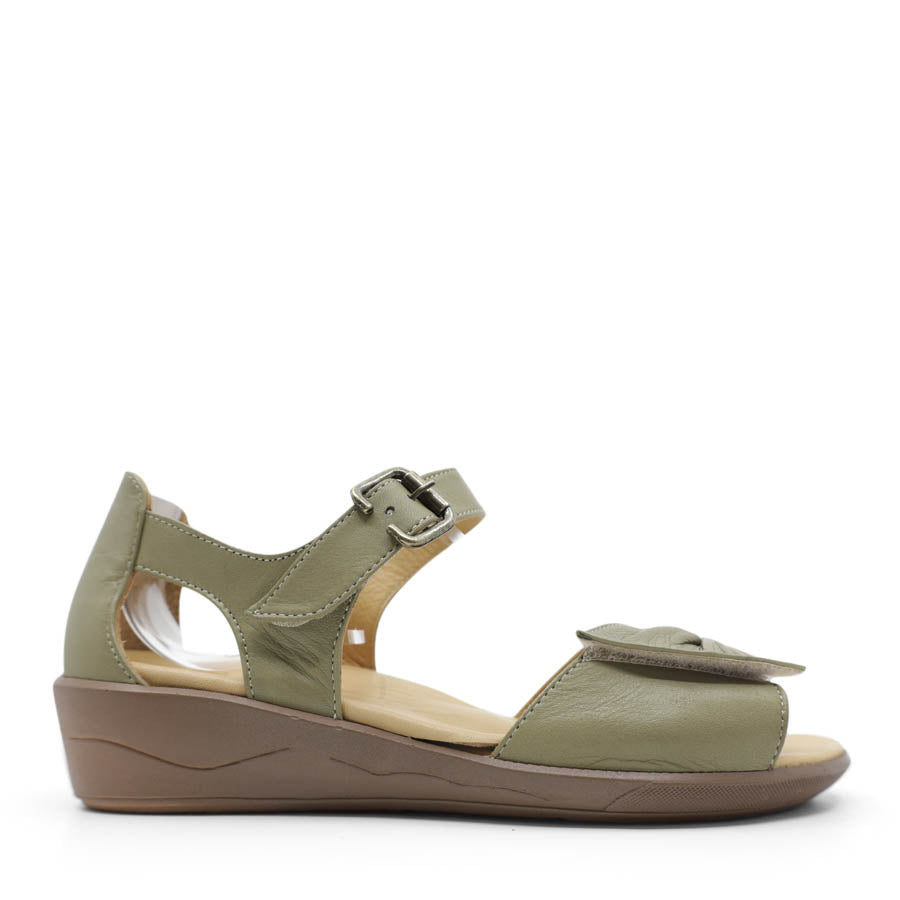 SIDE VIEW OF GREEN DUAL VELCRO CLOSED BACK SANDAL WITH DECORATIVE BUCKLE 