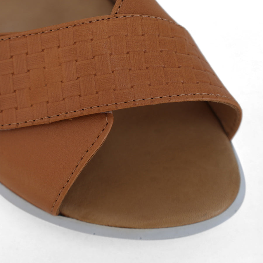 FRONT VIEW OF TAN OPEN TOE SANDAL WITH TWO VELCRO STRAPS AND WHITE SOLE