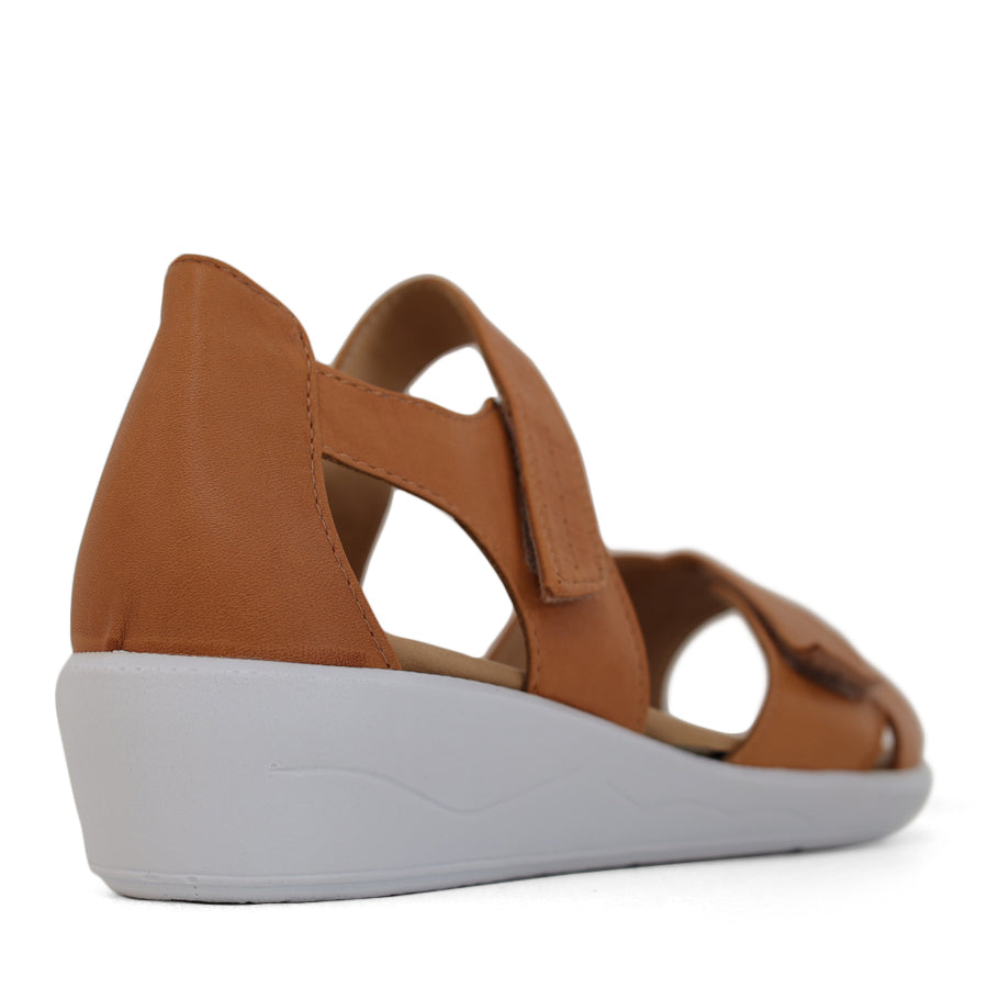 BACK VIEW OF TAN OPEN TOE SANDAL WITH TWO VELCRO STRAPS AND WHITE SOLE